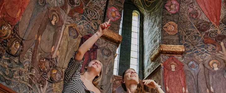 A picture of 2 ladies look up at the Watts Chapel roof at Watts Gallery