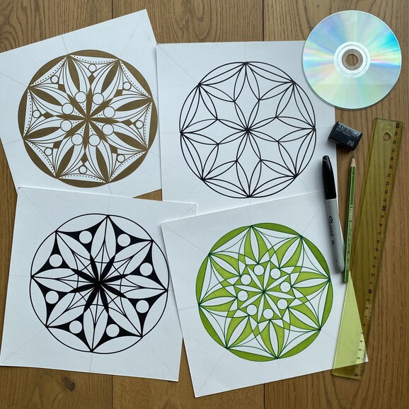 A table with a green and yellow draw mandala. Surrounded by drawing tools, a pencil, pen, ruler, stencils and a disc.