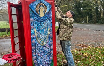 Chris Sharples decorates the Compton phone box with fir branches