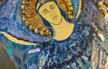 A Watts Chapel angel decorated in blue collage