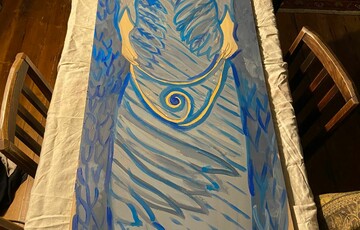 A Watts Chapel angel fully painted in shades of blue