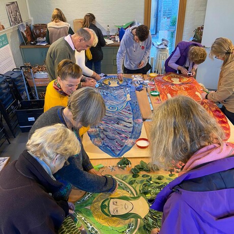 A group of volunteers gathered in the Foyle collaging the phone box angels