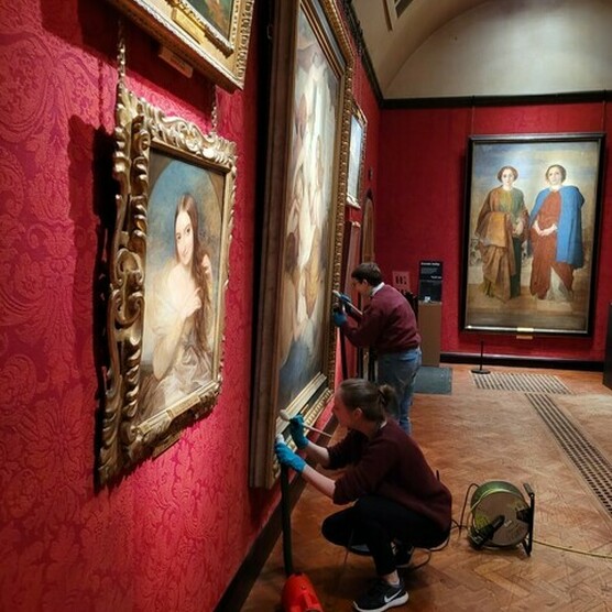 Rebecca is cleaning the art work