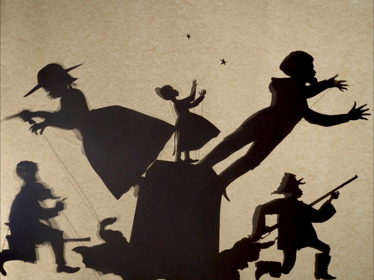 Cut-paper silhouettes of various figures on a brown background