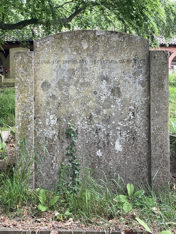 a large grave stone monument sitting in the middle of a field