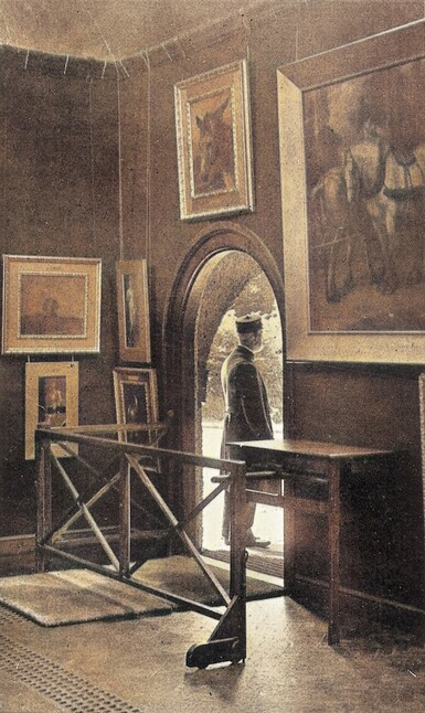 A colour photograph of a man stood in the door way of Watts Gallery
