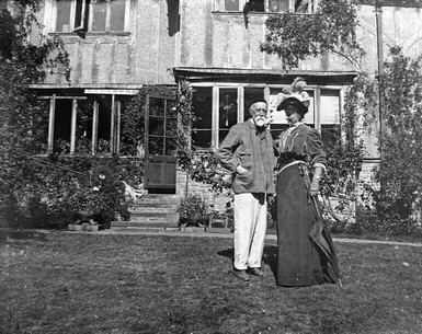 A black and white photograph of George and Mary Watts stood outside Limnerslease on the lawn
