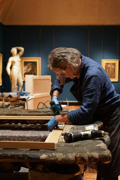 Frame conservator Tom Proctor repairing a frame in the Galleries at Watts Gallery - Artists' Village