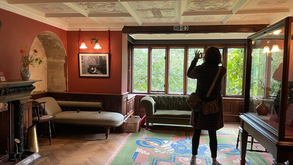 Photo of Kay Aplin taking a photo inside Limnerslease