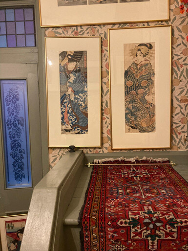 Photograph of a wall in Frank Milner's home, featuring framed woodblock prints