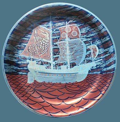 Lustreware dish of a blue ship on a red coloured sea, with red sails that have designs on them. The sky is a mixture of light blue, dark blue with bits of red throughout