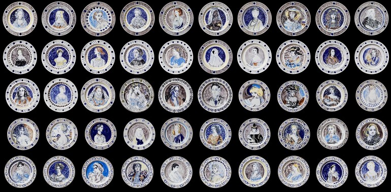 Photo of a series of dinner plates featuring portraits of women using blue pigment.