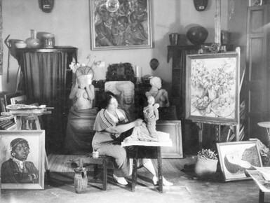 Photo of Irma Stern sculpting in her studio