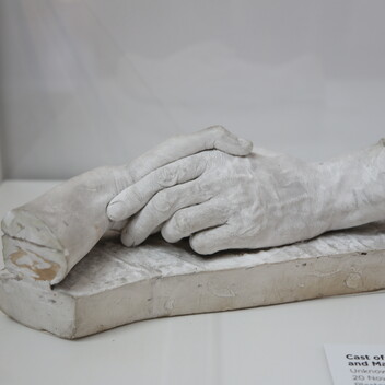 A cast of two hands holding