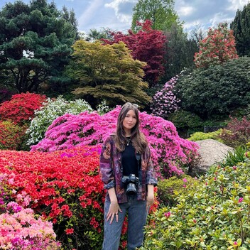 Lottie stands in a garden
