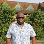 Henry stands outside the gallery looking at camera