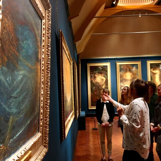 People looking at a painting in gallery