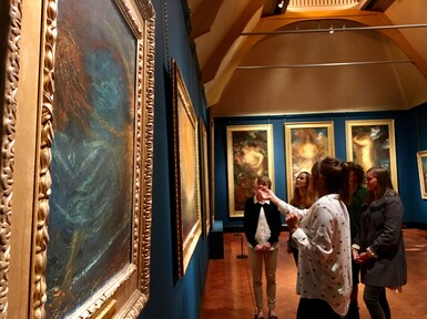 People looking at a painting in gallery