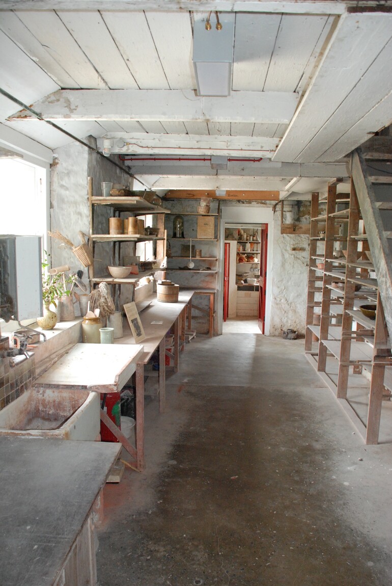 Photo of a small pottery studio with low ceilings
