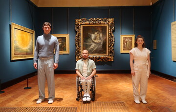 The dancers in Chris Pavia's Into the Waves stand in a line in the Historic Gallery in front of Francesca and Paolo