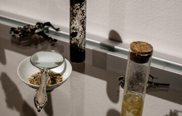 Installation photo of a magnifying glass, a small bottle and a trinket tray