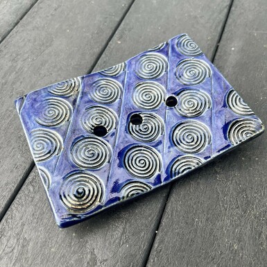 A blue ceramic rectangle soap dish
