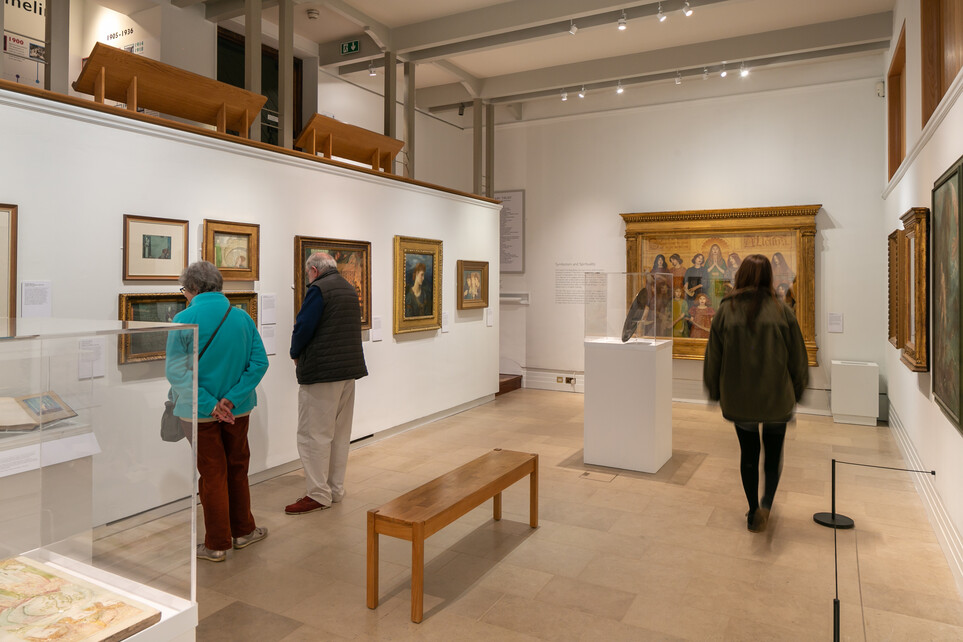 Three people looking around the Dreams and Stories exhibition