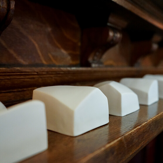 Close-up photo of small porcelain sculptures on a mantlepiece