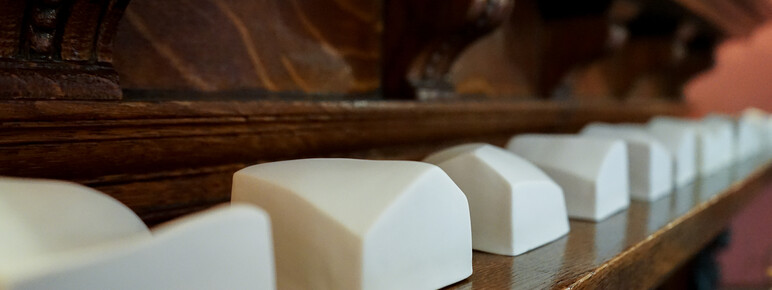 Close-up photo of small porcelain sculptures on a mantlepiece