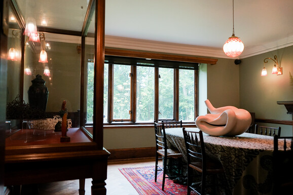 Photo of a white abstract ceramic sculpture placed on a dining room table