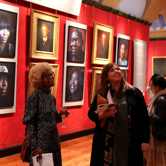 Two visitors look at art in Historic Galleries