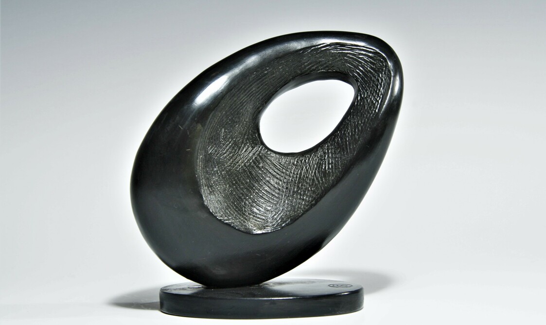 an abstract semi circle shape with a circle cut out the centre