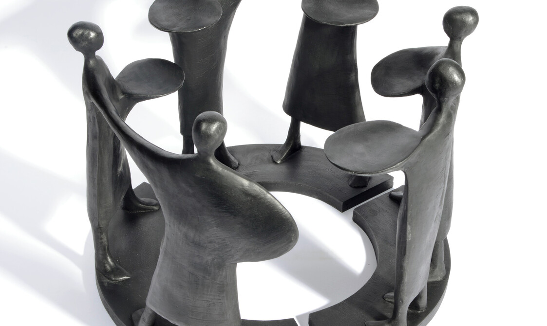 Six black abstract figures arranged in a circle