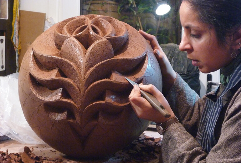Halima Cassell working on artwork in her studio