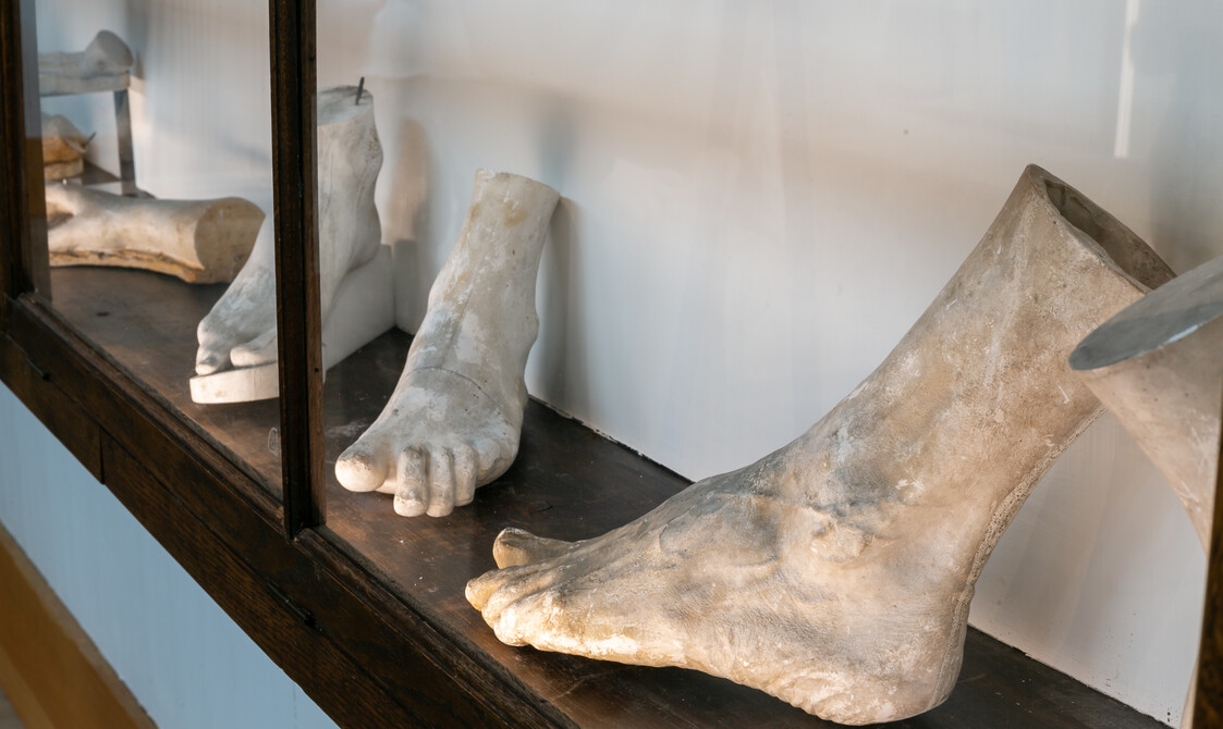 Photo of plaster casts of feet in the Watts Sculpture studio for A Fragmented Legacy exhibition