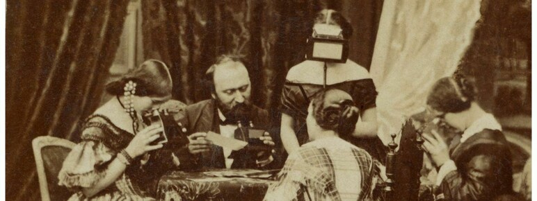 Stereo photograph of a Victorian family looking at stereo photographs and stereoscopes