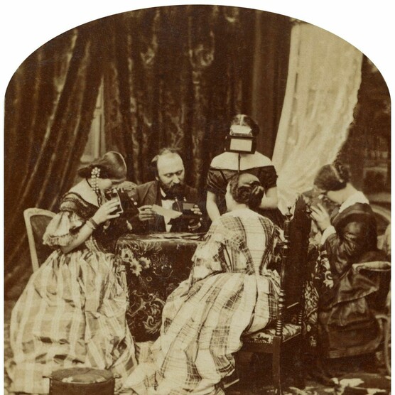 Stereo photograph of a Victorian family looking at stereo photographs and stereoscopes