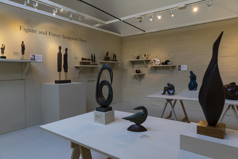 An exhibition of ceramics and sculpture, placed on shelves on the walls and on table tops in the Watts Contemporary Gallery