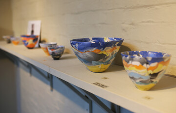 Brightly coloured bowls on a shelf