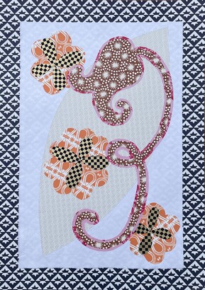 Collage using different patterned paper which is cut into flower shapes on a white background with a black and white geometric pattern border. The main flower in the middle is in the shape of a bluebell..