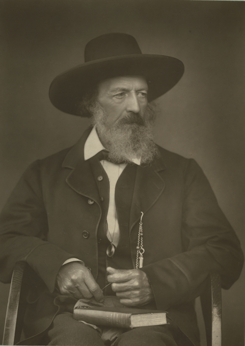 Sepia toned photograph of Alfred, he wears a smart jacket and wide-brimmed hat