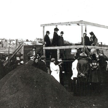 Archive photograph of G F Watts surrounded by the local community in Compton laying the foundation stone to Watts Gallery