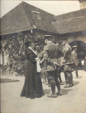 Archive photograph of Mary Watts talking to soldiers outside the Watts Gallery