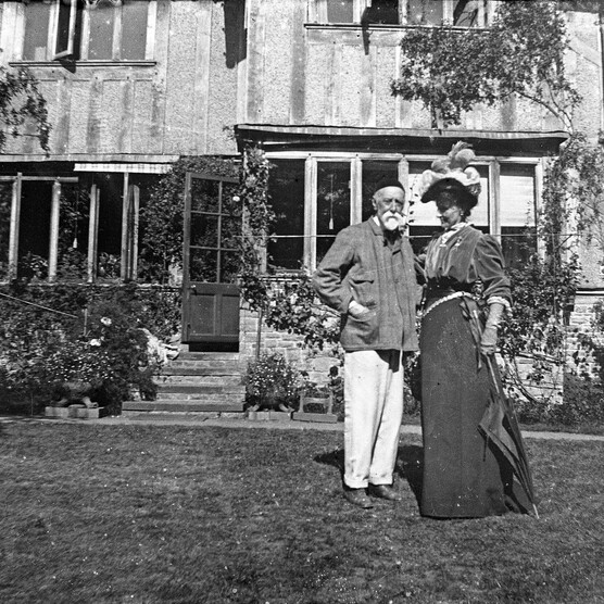 Black and white photo a couple outside their home