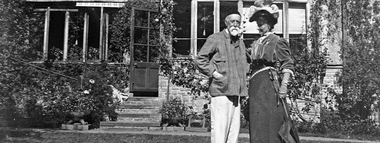 Black and white photo a couple outside their home