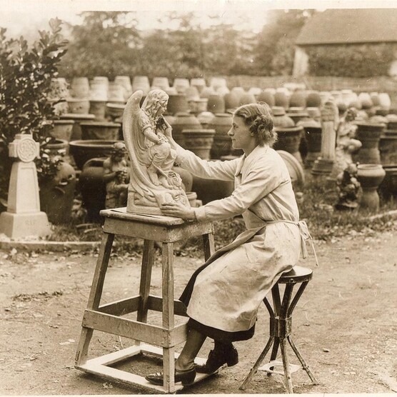 A women works on a ceramic piece at Compton Pottery