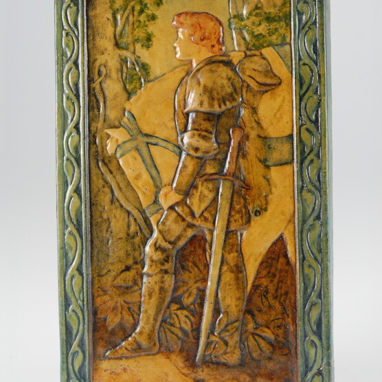 Yellow toned ceramic plaque with a knight and horse