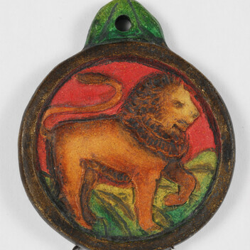 Brightly coloured circular pendant with lion on