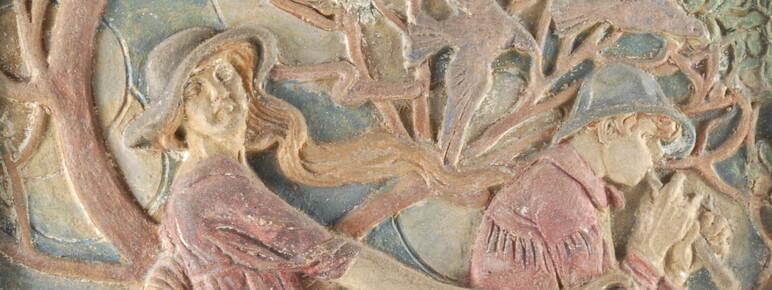 A pottery relief of a girl in a pink dress harvesting a field while a young man sits nearby