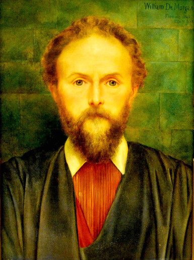 A bright painted portrait of a young William De Morgan standing in front of a green tile background. He wears a black jacket and red cravat